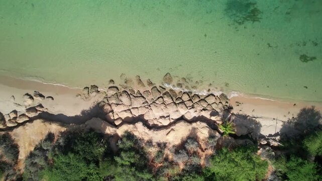 Zenith aerial view Araya beach rocky breakwater turquoise sea