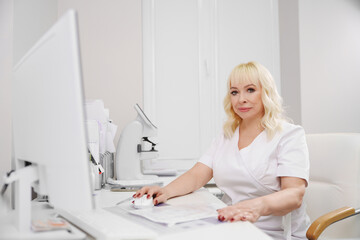 Ophthalmologist works at office during patient consultation