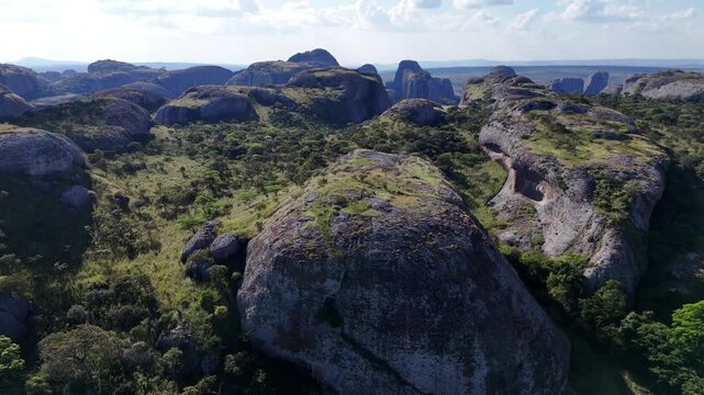 Cinematic flight exploring the ancient stone giants of the Pungo Andongo region in Malanje, Angola, Africa, from a high-angle view during sunset