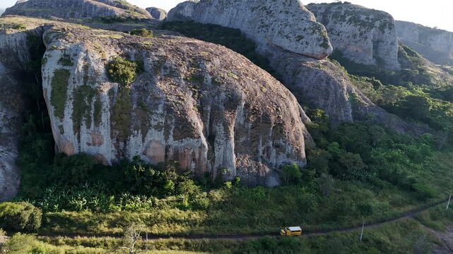 Low-altitude aerial journey past the sheer vertical walls of Pedras Negras de Pungo Andongo in the Malanje Province, Angola, Africa