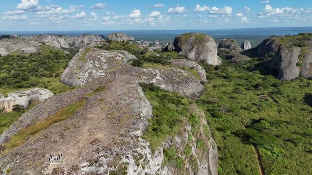 Cinematic aerial vista of the expansive Pedras Negras de Pungo Andongo rock field in the Malanje Province, Angola, Africa, during the peak of the green season