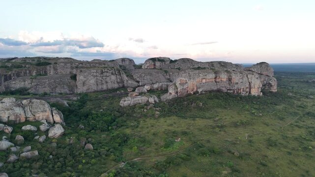 Aerial drone perspective of the massive volcanic monoliths known as Pedras Negras (Black Rocks) in the Pungo Andongo region of Angola, green African plains