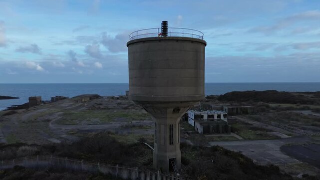Disused Octel chemical facility aerial view circling abandoned industrial factory water tower coast