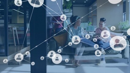 Animation of network of connections with icons over diverse business people in office - Powered by Adobe