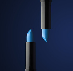 two beautiful blue lipsticks in a black case on a dark background