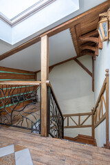 Rustic Wooden Staircase Interior with Skylight and Iron Railing