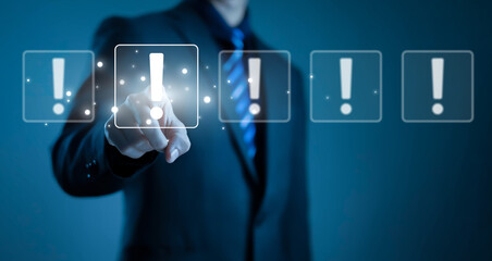 Businessman touching virtual warning alert icon on digital interface, representing risk management, security alert, system notification, error message, and critical decision concept.