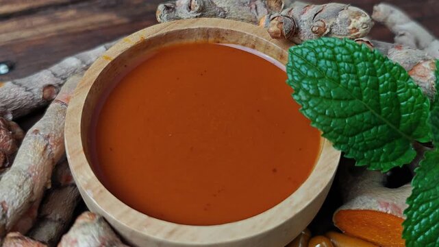 Turmeric drink and raw roots. Turmeric curcuma capsules. 