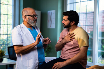 Indian physiotherapist with happy patient showing thumbs up after shoulder pain treatment