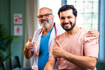 Experienced Indian physician and young patient smile confidently after positive medical checkup