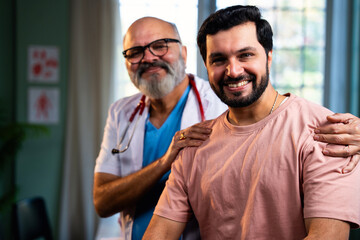 Experienced Indian physician and young patient smile confidently after positive medical checkup