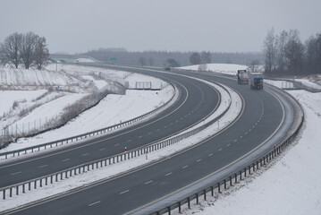 SNOWY AND FROSTY WINTER - Car traffic on the expressway on the claered of snow and not slippery