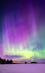 Northern lights dancing over frozen lake in north of Sweden.