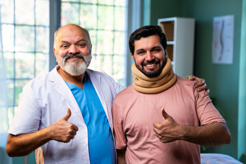 Indian physiotherapist treating young patient with neck and shoulder pain in clinic