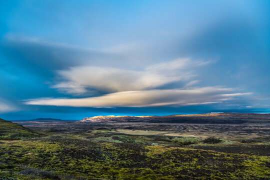 View of Iceland's Highlands reveal a raw landscape under a dramatic sky with sweeping clouds and contrasting light, casting shadows across the rugged terrain, Southern Iceland, Iceland.