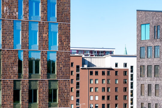Modern urban architecture with a building facade of brick and glass plus reflection in a quiet cityscape creating minimal contemporary geometry