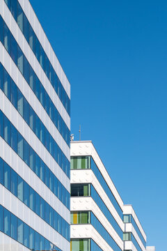 Modern highrise architecture with an urban building facade of windows and stripes in perspective rising into open sky for minimal design