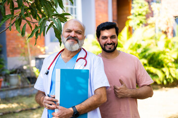 Indian doctor patient discuss case outdoors while reviewing medical details in nature