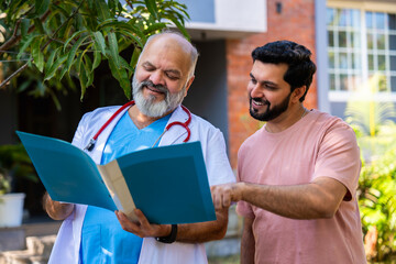 Indian doctor patient discuss case outdoors while reviewing medical details in nature