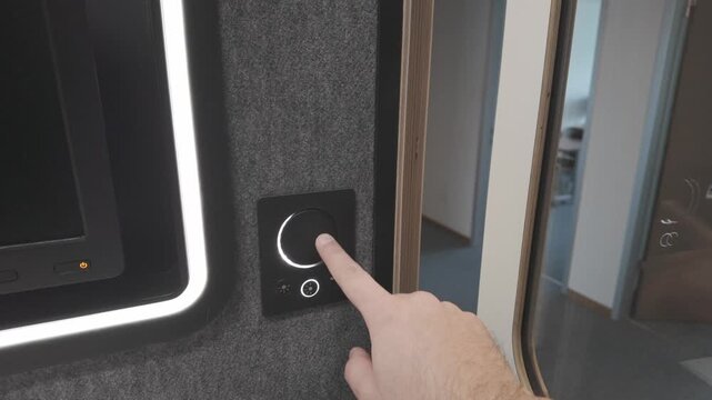 Diagonal top-left shot of a right hand rotating the smart dimmer dial with ne finger