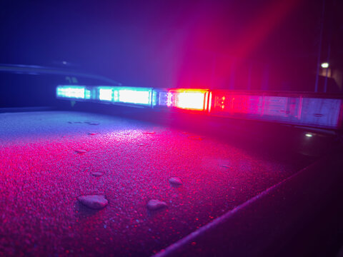 Police emergency blue and red lights from the light bar on the roof of the vehicle. 