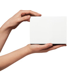 Person's hands holding up a plain white square object, creating empty copy space for displaying a custom message, product, or design against a neutral background