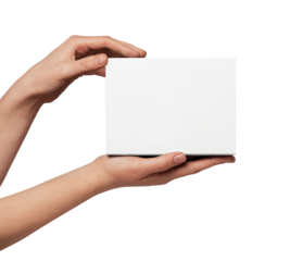 Person's hands holding up a plain white square object, creating empty copy space for displaying a custom message, product, or design against a neutral background
