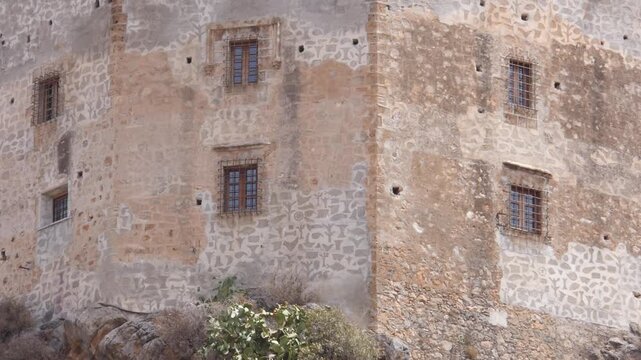 Nasrid tower in V&eacute;lez de Benaudalla, Granada. Detail of stone walls and old windows of a medieval fortress.