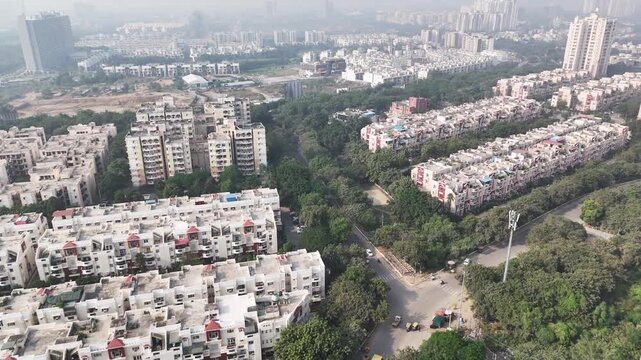 Wide aerial panorama of Jaypee Greens township, featuring tall residential complexes, internal roads, and surrounding greenery, reflecting Noida&rsquo;s planned urban development.