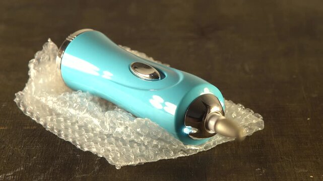 Portable stone attachment rotates on a grinder spin video with sound.