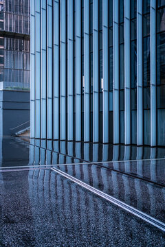 Urban architecture modern facade lines with reflection, wet minimal abstract textures and empty space for contemporary design background