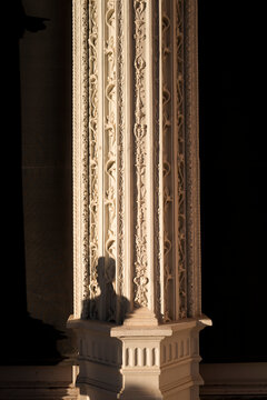 Suggestive image of classical Reinacese column style with decorations and mysterious human shadow.