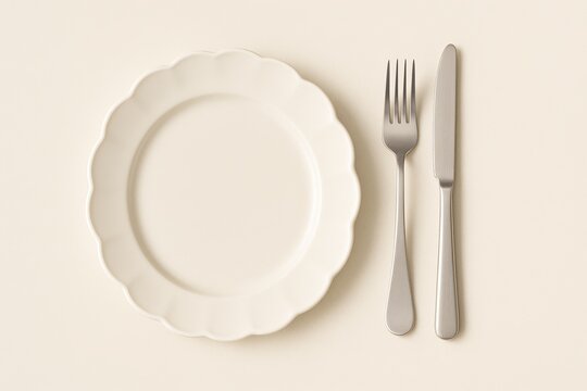Minimal Table Setting with White Scalloped Plate and Cutlery Top View