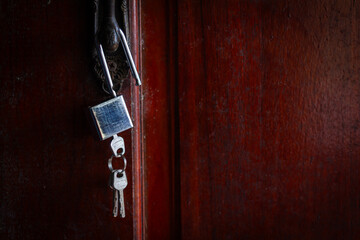 House key left hanging on an empty door symbolizes abandonment, separation, loneliness, and emotional loss.