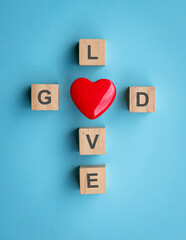 God is love with a red heart in the shape of a cross. 