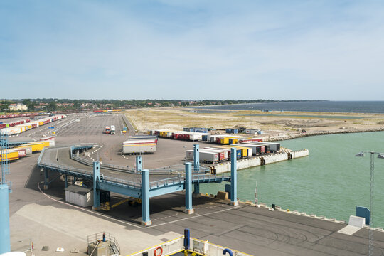 Trelleborg, Sweden - 22 July 2017: View of the bustling harbor, where rows of colorful cargo trailers stand ready for transport against the backdrop of the calm, azure sea.