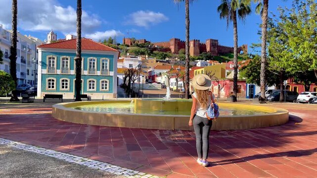 Woman tourist enjoying view of Silves castle in Portugal, Algarve