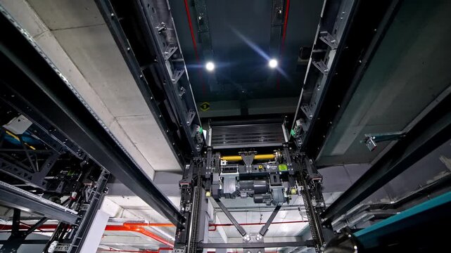 A fully automated smart parking system featuring robotic lifting platforms, mechanical rails, and LED-lit structures operating inside a high-tech multi-level indoor parking facility.