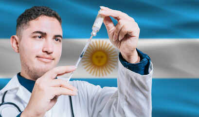 Doctor holding syringe on Argentina flag background. Medical professional holding syringe with Argentine flag in the background