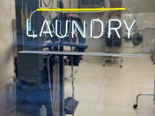 Neon laundry sign on a laundromat.