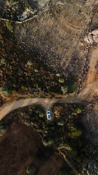 Van parked by Almendra Reservoir with rocky lakeside landscape, Spain