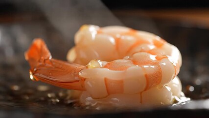 A perfectly cooked and peeled shrimp showcasing its vibrant orange and pink colors and delicate texture resting on a dark surface ready to be served as a delicious and healthy seafood appetizer or ma.