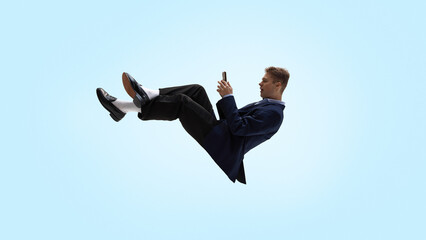 Business man levitating while texting on smartphone mid air. Concept of HR communication, internal messaging, approval flows, candidate coordination, employee updates and corporate chat workflows.