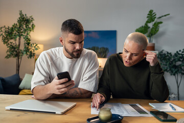 Couple managing home finances and discussing budget bills