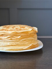 stack of pancakes. A plate of pancakes is on the table. A beautiful Maslenitsa breakfast.