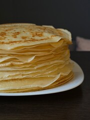 stack of pancakes. A plate of pancakes is on the table. A beautiful Maslenitsa breakfast.