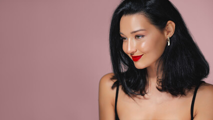 Fototapeta premium Elegant Brunette Model with Red Lips and Glowing Skin Beauty Portrait