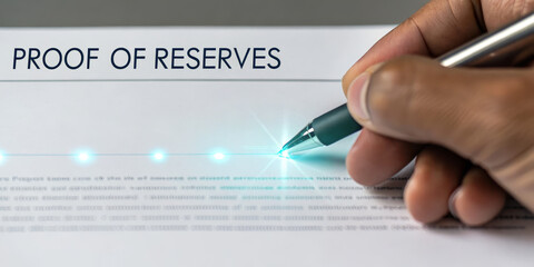 Proof of reserves digital signature hand holding pen close up document verification financial audit secure authentication technology business trust transparency