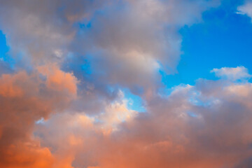 Dramatic sunset sky with orange and gray cloud formations.