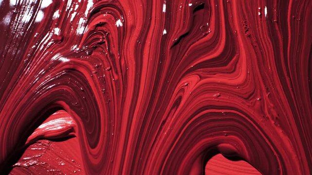 Abstract swirling red and maroon paint texture background